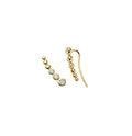 Gold earrings with small round stones on a white background