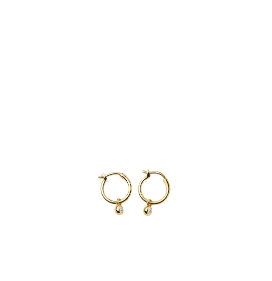 Gold hoop earrings with small round pendants on a white background