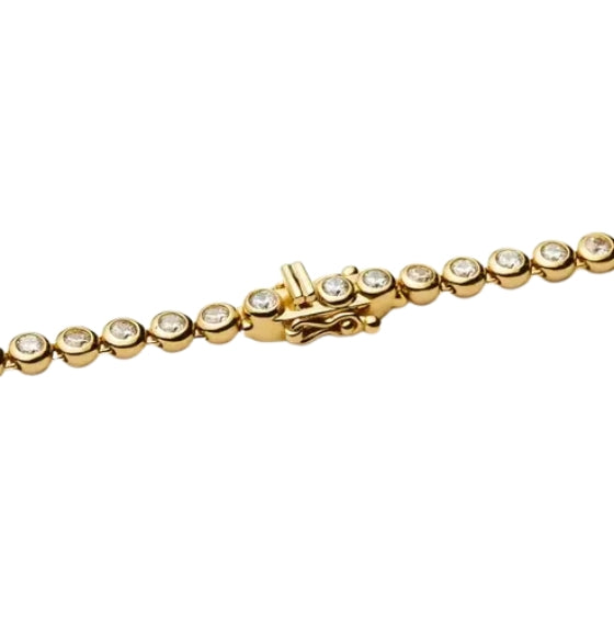 Gold bracelet with diamond-like stones on a white background