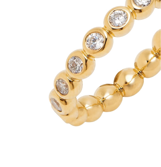 Gold bracelet with gemstones on a white background