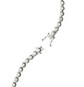Silver bracelet with clear gemstones on a white background