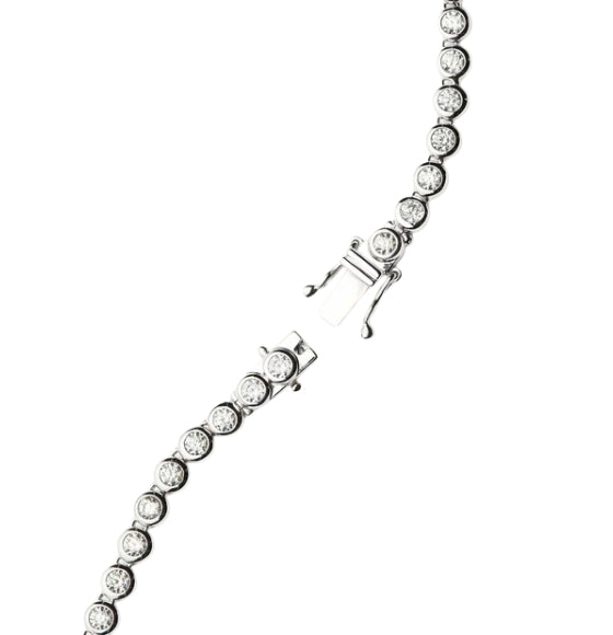 Silver bracelet with clear gemstones on a white background