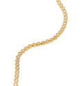 Gold necklace with small round beads on a white background