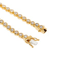 Gold bracelet with clear stones on a white background