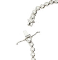Silver bracelet with clear gemstones on a white background
